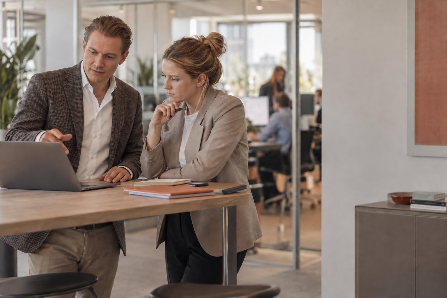 A Managed Claire consultant walks a client through the monthly report on a laptop